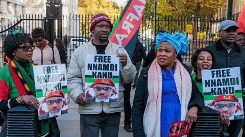 Getty Images A group pf men and women hold placards saying: Free Nnamdi Kanu